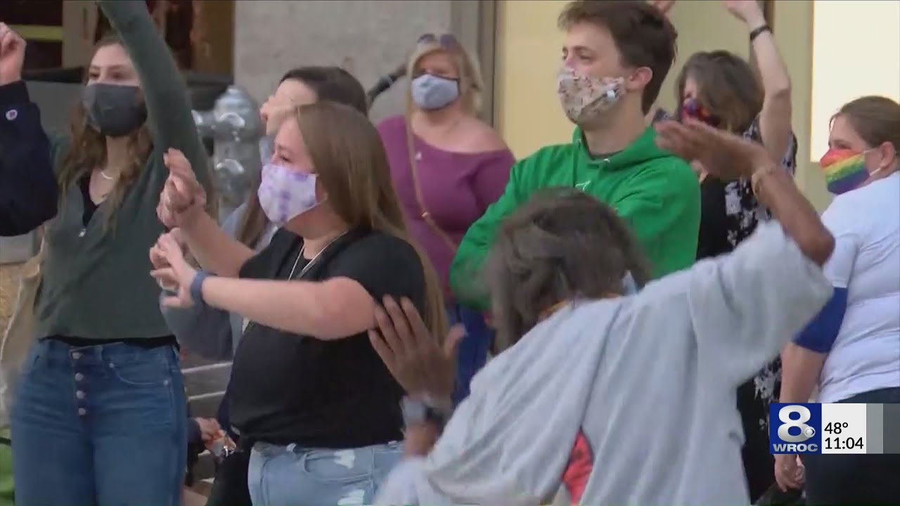 Celebration breaks out at Liberty Pole after election results, people discussing change