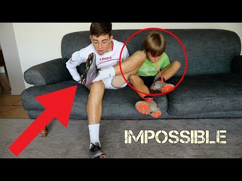 TRYING TO TAKE OFF FOOTBALL BOOTS AND SOCKS WITHOUT HANDS (FORFEIT)