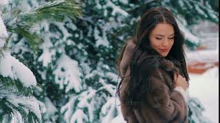 Brunette woman shake snow from winter pine branches slow motion screenshot 1