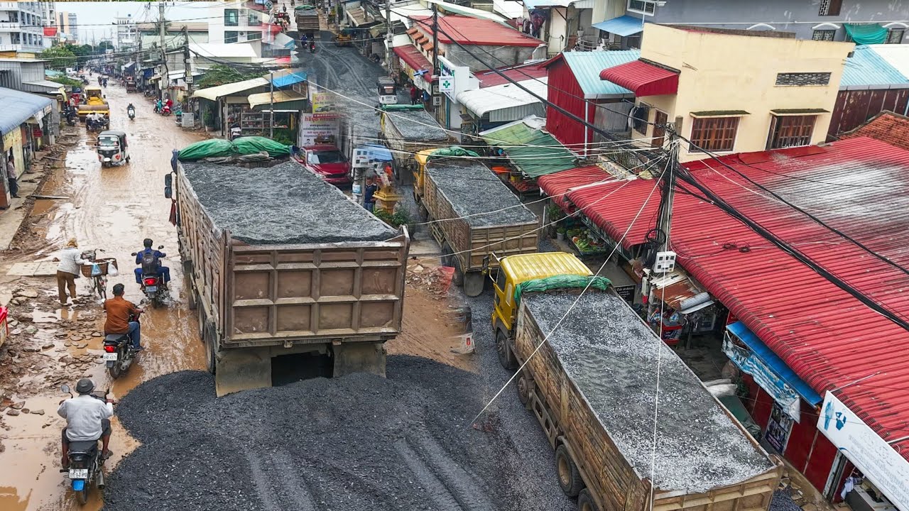 12Wheel Dump truck dumping gravel build Foundation road in Village by Skill Dozer Spreading Gravel