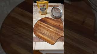 How to dust pizza peel with corn meal