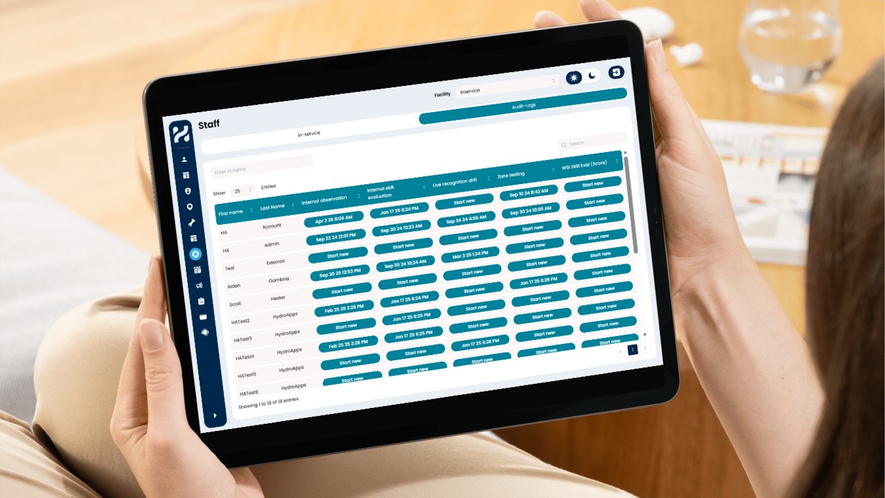 Person holding a tablet displaying the HydroApps Staff Manager audit logs, showing staff audit status, evaluation history, and options to start new audits.