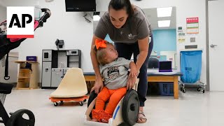 Custom made chairs help disabled toddlers get moving
