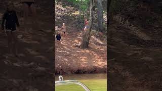 Girl attempts to ride rope swing then rope gets wrapped behind tree and she faceplants on dirt ledge