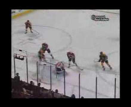 Martin Biron stops a slap shot by Bruins Patrice B...