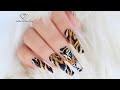 Painting tiger on the nails. Animal print nail art tutorial.