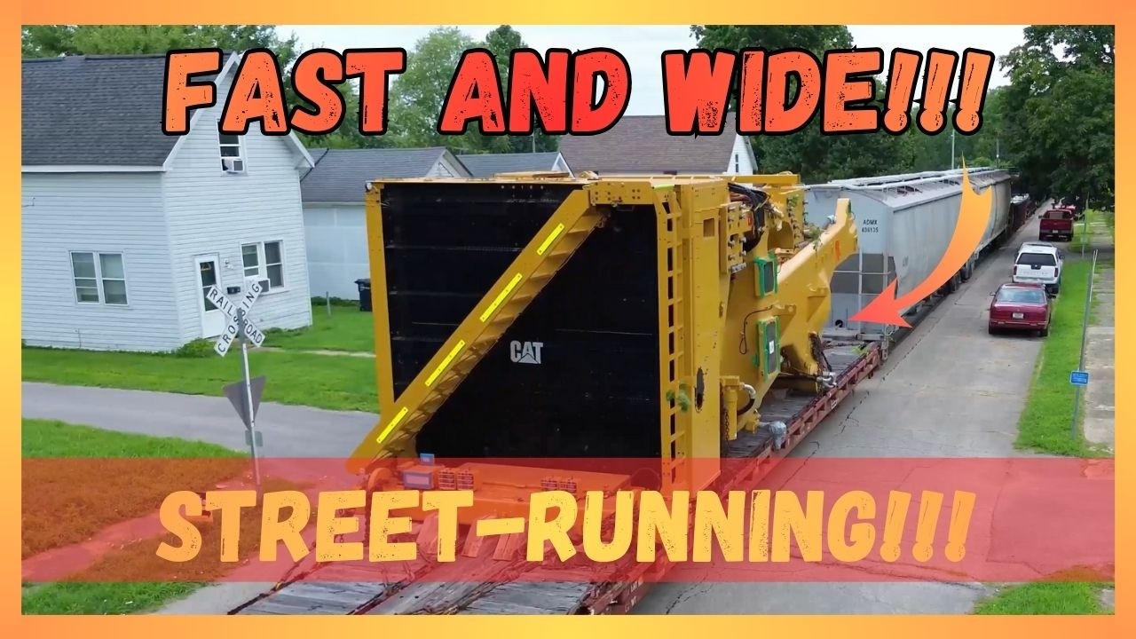 Wide load doesn't slow down as it rolls through a neighborhood! Parked cars on both sides of street!