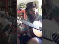 Disheveled looking bearded guy plays blues on nylon guitar