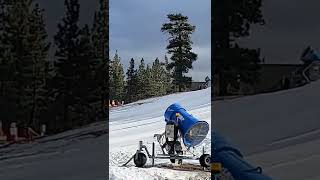 Guy rides snow tube down ski slope then crashes into little boy and he flips over