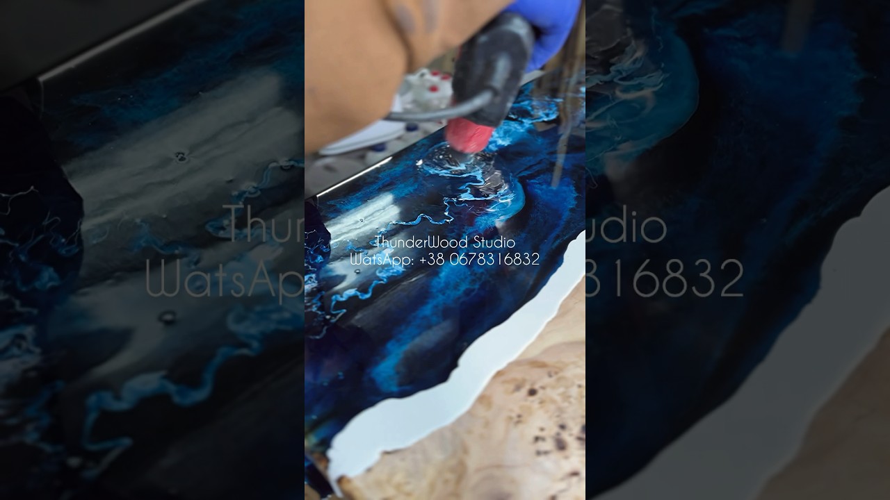 Creation to order, a table made of natural wood and dark blue resin