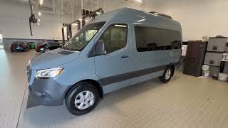 Show me a 12-seater Mercedes Sprinter Van, seating, legroom, cargo space, features, tall roof, 2023