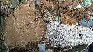 cutting bent wood into simple house construction blocks