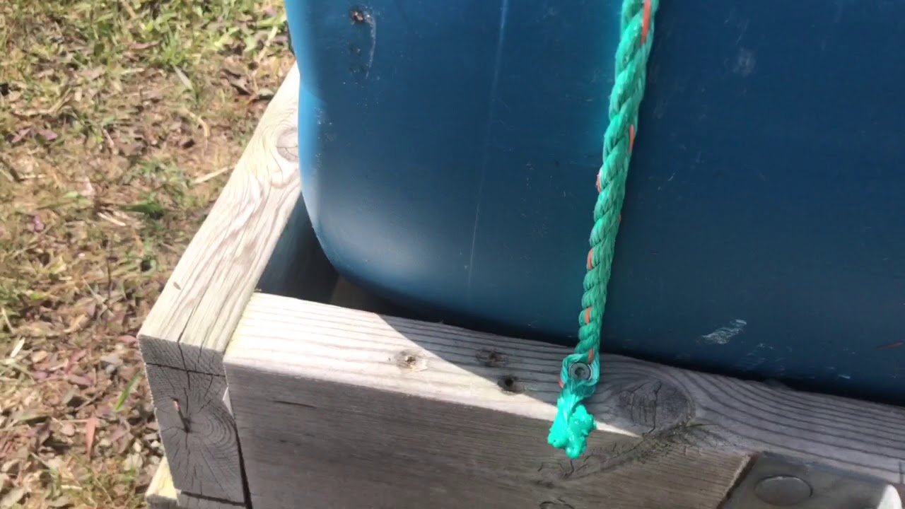 Using rope to secure barrels on floating dock - YouTube