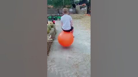 Boy Bouncing on Orange Hopper Ball