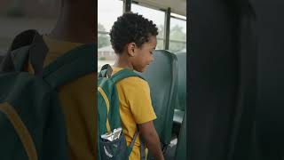 Child cleaning the seat while leaving the school bus