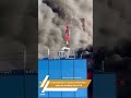 VIDEO | Crane operator rescues man from burning building in England