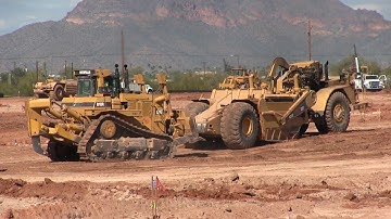 Caterpillar 631E Scrapers Spinning Their Wheels Waiting For The Push-CAT