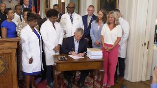 Watch: North Carolina governor signs $34 billion budget proposal