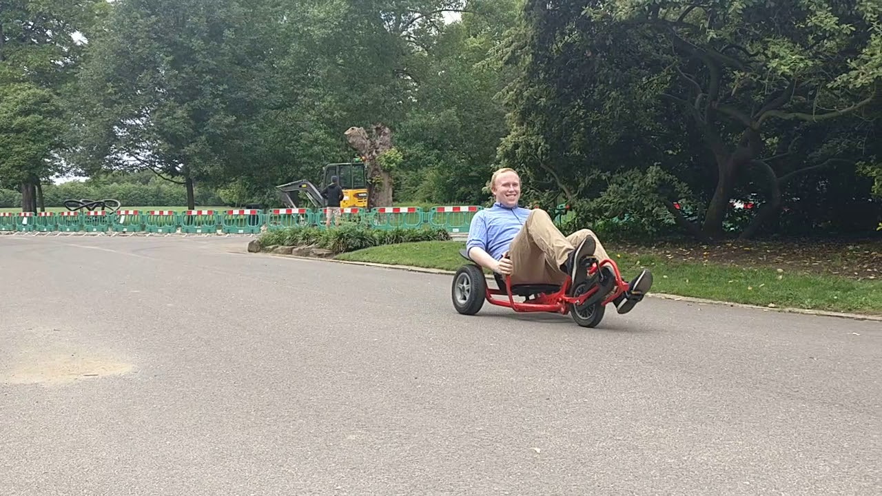 Sam rides the recumbent bike. Back in Dulwich Park Again 11 years later