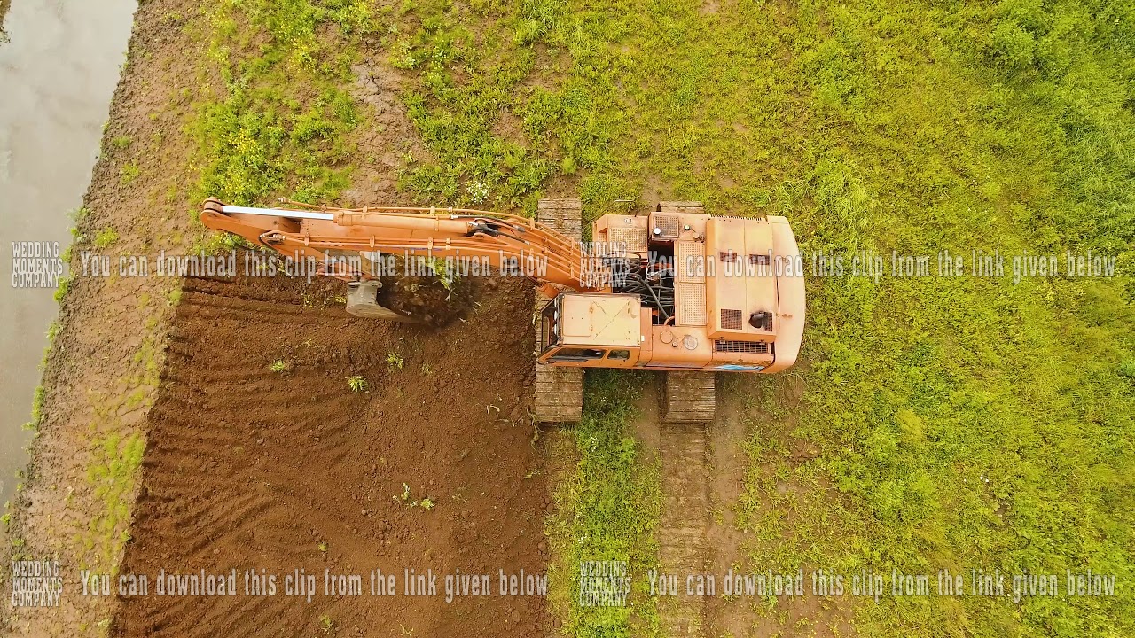 Excavator digging a trench in the field.Aerial video. - YouTube