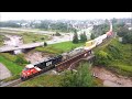 Nice aerial 4k view brand new tier 4 gevo 3292 leads a huge stack train cn 120 wdpu at moncton nb