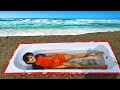 Bathtub buried in sand at the beach - ADEL ET SAMI