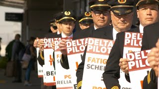 Overcome with fatigue, Delta pilots picket at Salt Lake City Int'l Airport