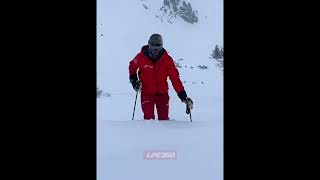 Guy walking in powder of snow on skies
