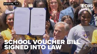 Texas governor celebrates as controversial school voucher bill signed into law