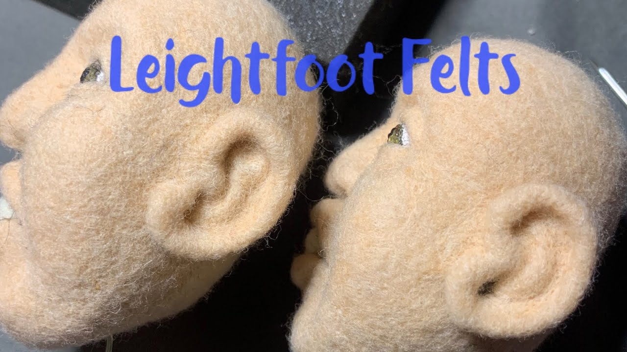 Needle felting a doll, adding ears.