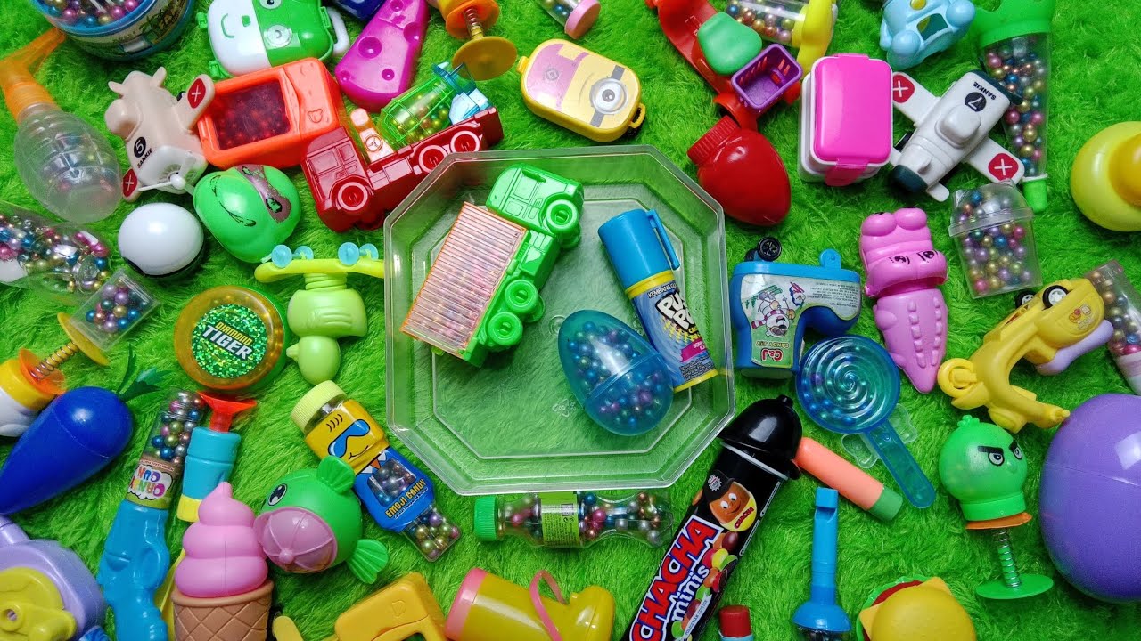 Asmr video shares the characters of plastic candy containe truck, egg, push pop and color balls
