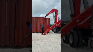 Boxloader off loading a full container - Bajan at work.