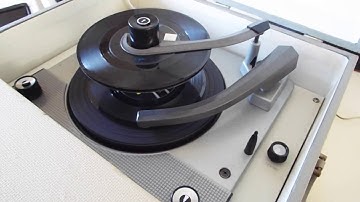 Columbia stereo record player playing a stack of 45