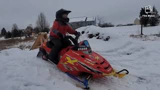 7 year old jumping and testing out his modified polaris 120 snowmobile