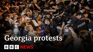 Georgia: Protesters hit by police water cannons after passing of 'Russian inspired' bill | BBC News