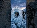 The woman's sledgehammer impacts the frozen deer's chest. The ice shatters violently into a million