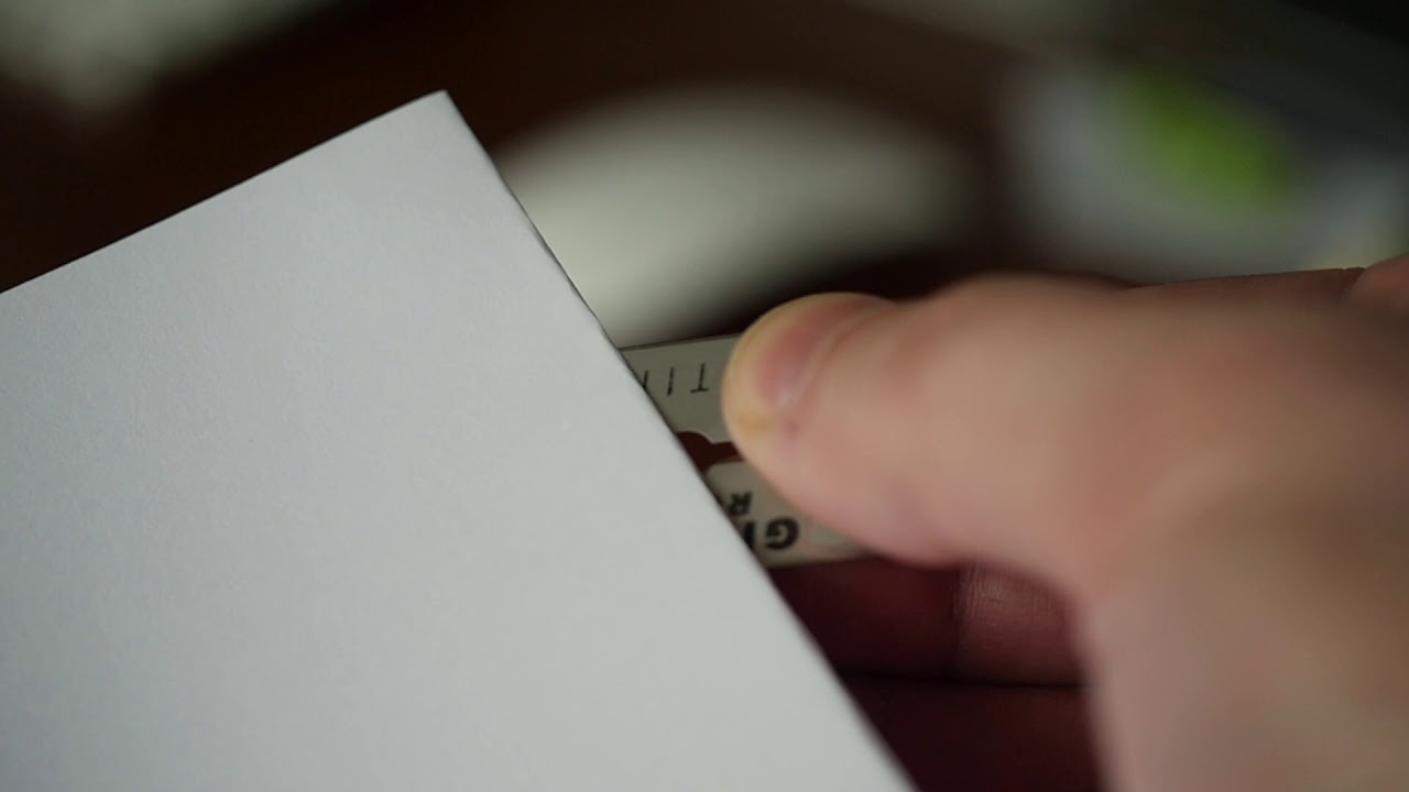 A blade razor cuts a white sheet of paper. Free HD video footage - YouTube