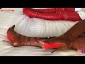 Red and brown thigh boots with long leather gloves lying side by side-春节的大腿靴