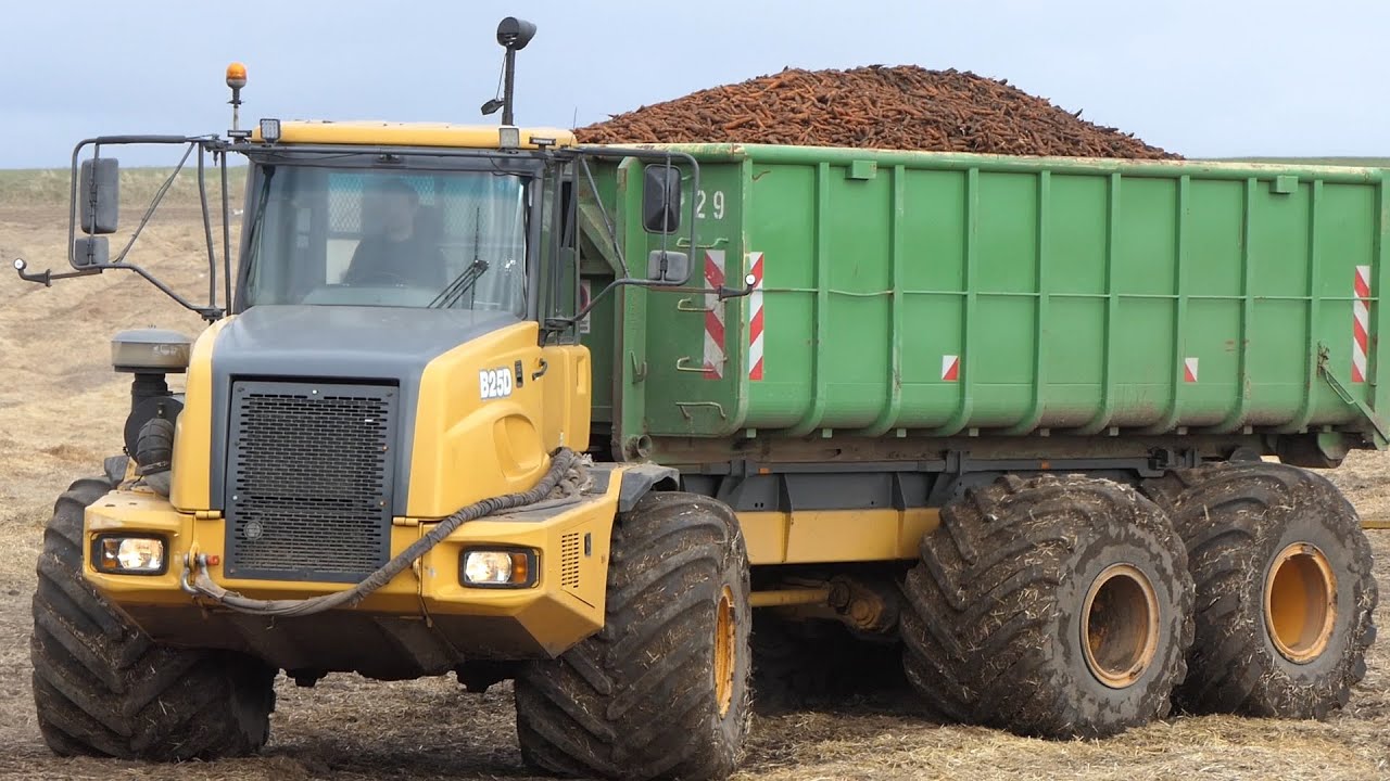 Bell B25D DumpTruck in the field carrying containers filled with