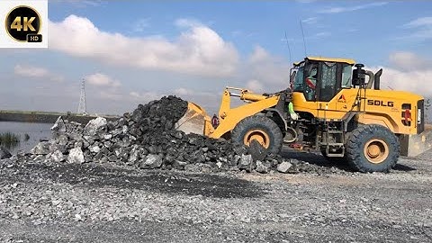 The Heavy Machine Equipment On Construction Wheel Loaders Push & Uploading Rock By Dump Truck  MAN.