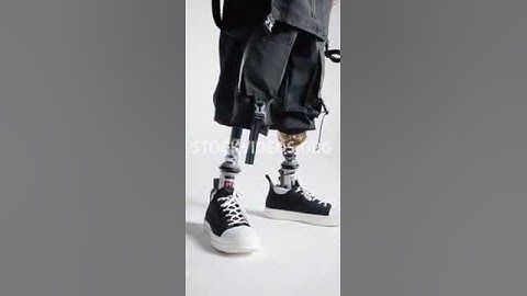 stock video footage - man with both prosthetic legs walking by, artificial limb