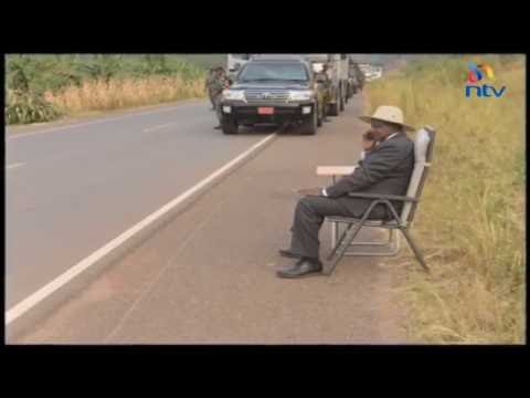 President Museveni answers a phone call by the roadside