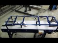 Dual belt conveyor for product turning