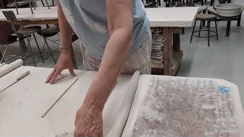 Rolling a clay slab using a rolling pin