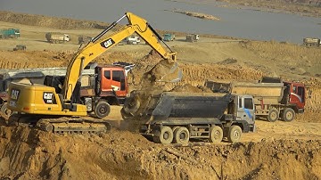 Caterpillar 320 Excavator Digging Soil Loading Into Dump Truck With Skill Operator