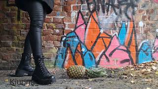Crush pineapple  with worker boots