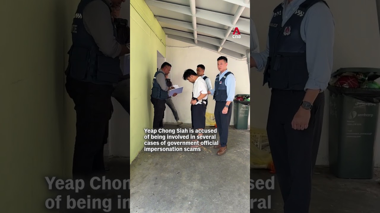 Government official impersonation scam suspect brought back to crime scene