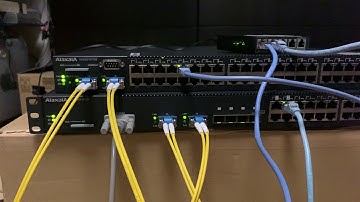 Two solitary Ethernet switches, blinking their lights together [10GBASE-LR LACP action]
