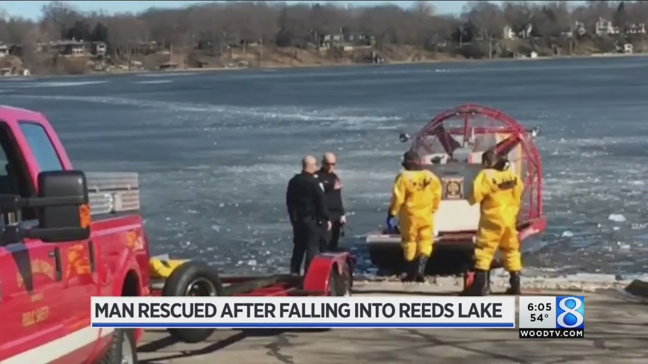 Fire crews rescue man who fell through ice on Reeds Lake - YouTube