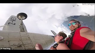 Skydivers get stuck on plane's landing gear | Video